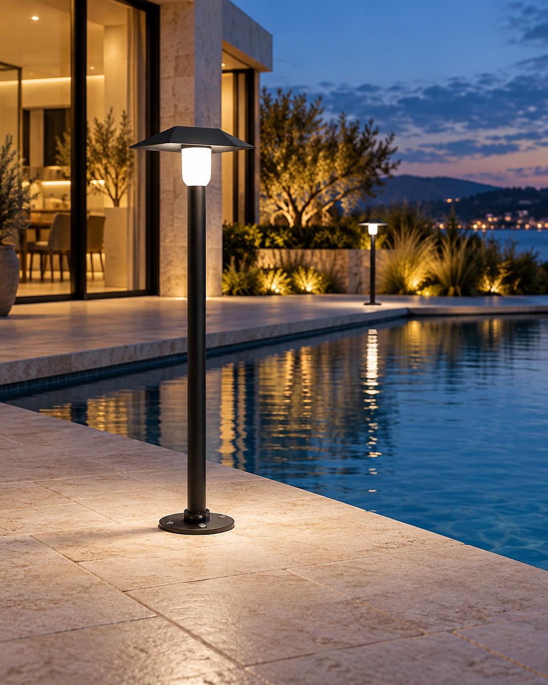 Sylvane black aluminum LED path light in a landscaped outdoor setting